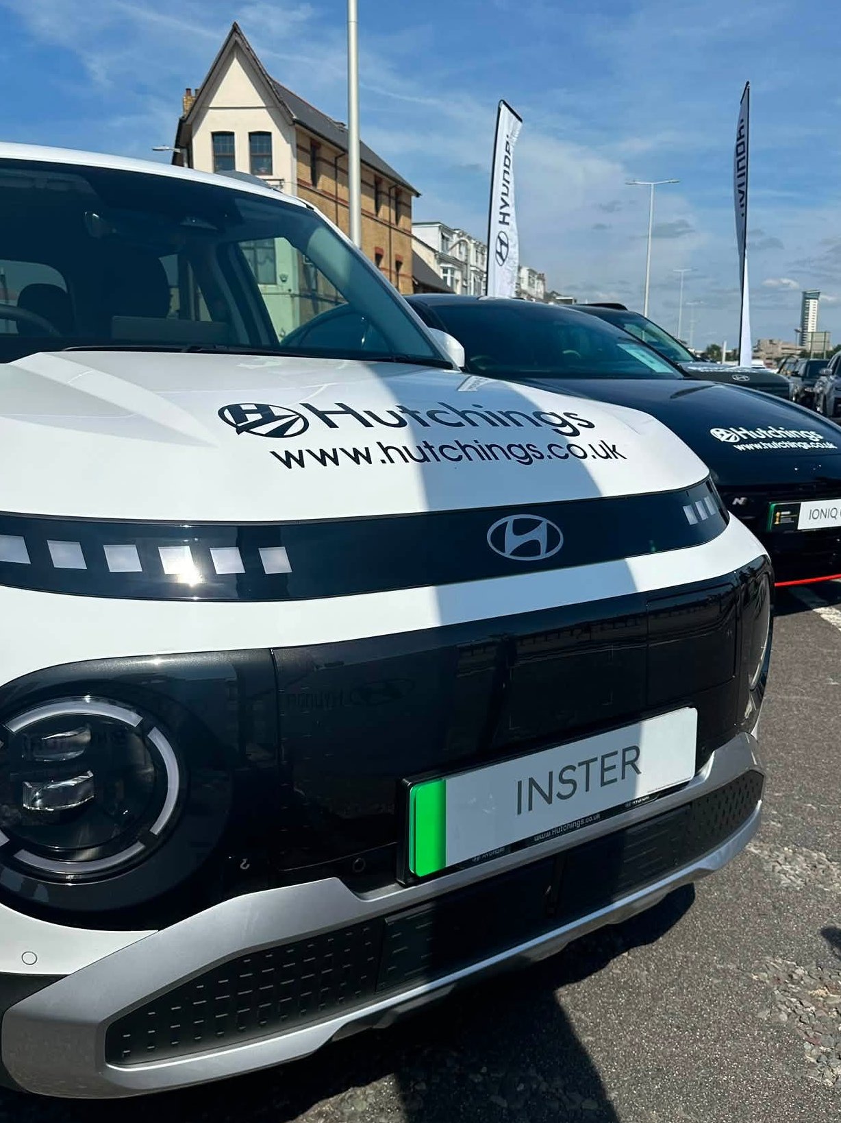 Front view of white Hyundai car with Hutchings branding on the bonnet.