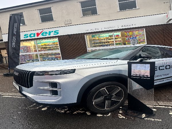 Silver SUV parked outside a Savers store.