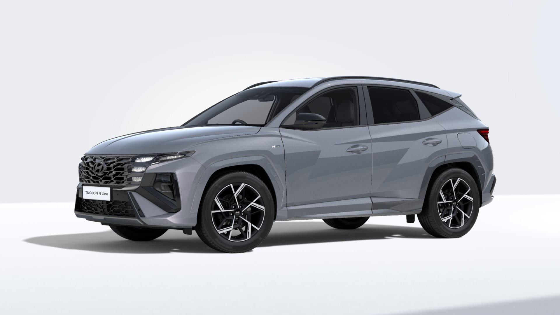 Grey SUV, front-right angle, with sporty design and black alloy wheels.